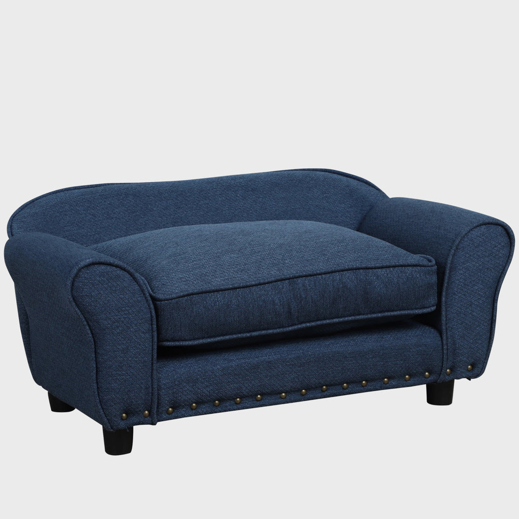 Blue sofa with nailhead trim on a white background