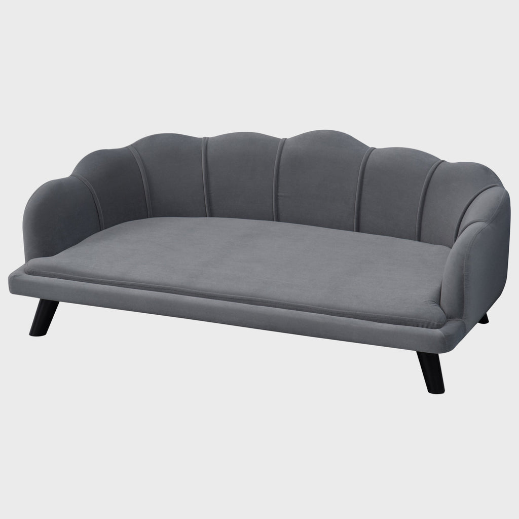 Gray sofa with scalloped backrest on a white background