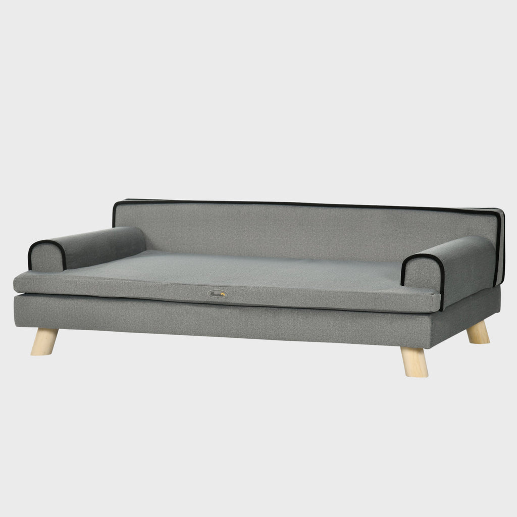 Gray pet bed with black trim on a white background